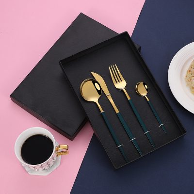 Elegant gold and black cutlery set in a sleek black box, perfect for sophisticated dining and gift-giving. Monalisa Store offers stylish tableware for home and special occasions.