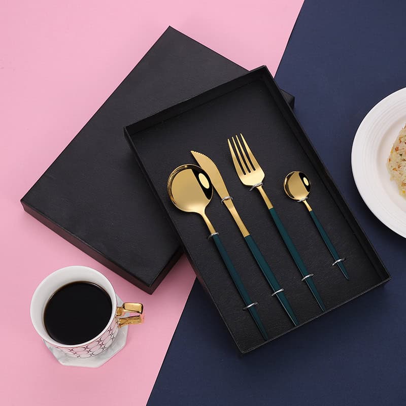 Elegant gold and black cutlery set in a sleek black box, perfect for sophisticated dining and gift-giving. Monalisa Store offers stylish tableware for home and special occasions.