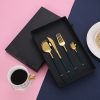 Elegant gold and navy utensil set in black gift box on colorful background for Monalisa Medical opt store.