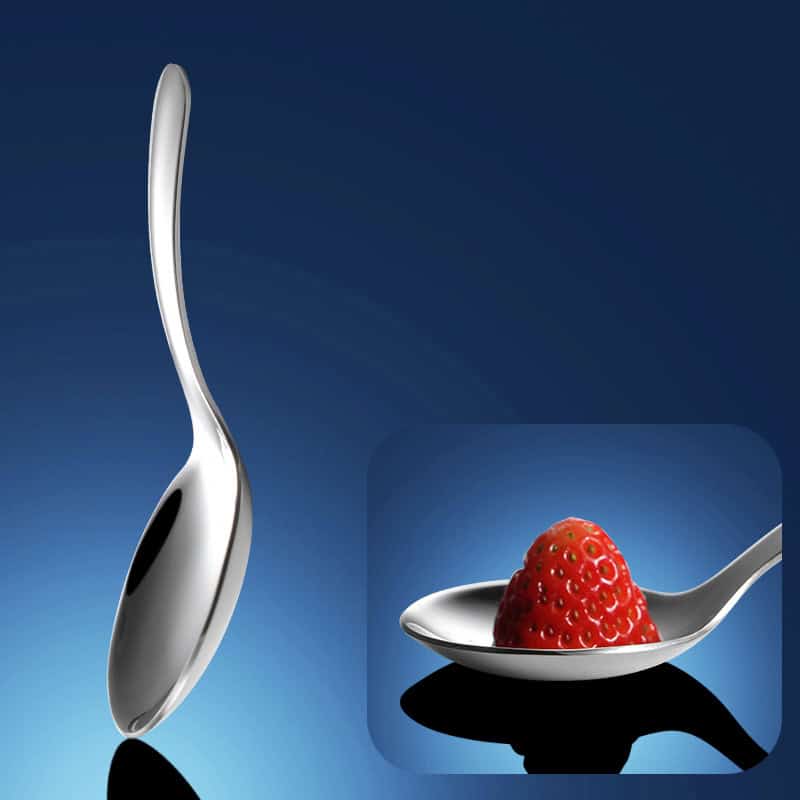 Stainless steel spoon with a sleek, curved design and a close-up of a fresh strawberry on a matching spoon, showcasing elegant and high-quality kitchenware for optometrists and eyewear enthusiasts.