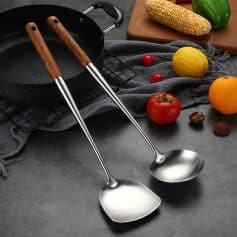 Stainless steel kitchen utensils with wooden handles, ideal for cooking and food preparation.