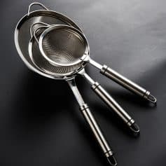 Stainless steel kitchen sieves and strainers set, professional-quality kitchen tools for cooking and food preparation. Durable and easy to clean, perfect for baking, straining, and sifting.