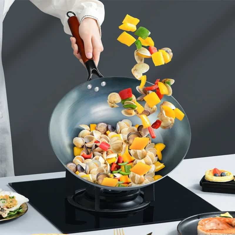 Fresh vegetables and mushrooms being stir-fried in a non-stick pan, highlighting healthy cooking options and vibrant ingredients for a nutritious meal.