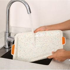 Reusable splash guard for kitchen sink, cleaning, or personal care use, with vibrant confetti pattern, designed for easy installation and hygiene maintenance.