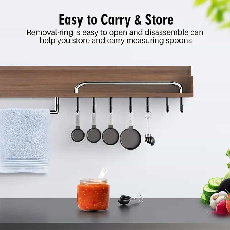 Stainless steel hanging pot rack with removable rings for easy storage and organization of cookware in kitchen, featuring mounted utensils and clutter-free countertop space.
