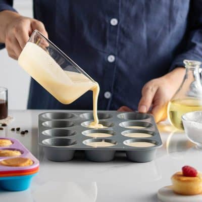 Cream being poured into a silicone mold for baked goods or desserts at Monalisa Store, specializing in optical and eyewear products.