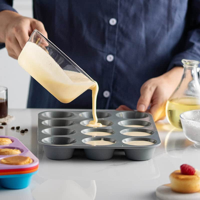 Cream being poured into a silicone mold for baked goods or desserts at Monalisa Store, specializing in optical and eyewear products.