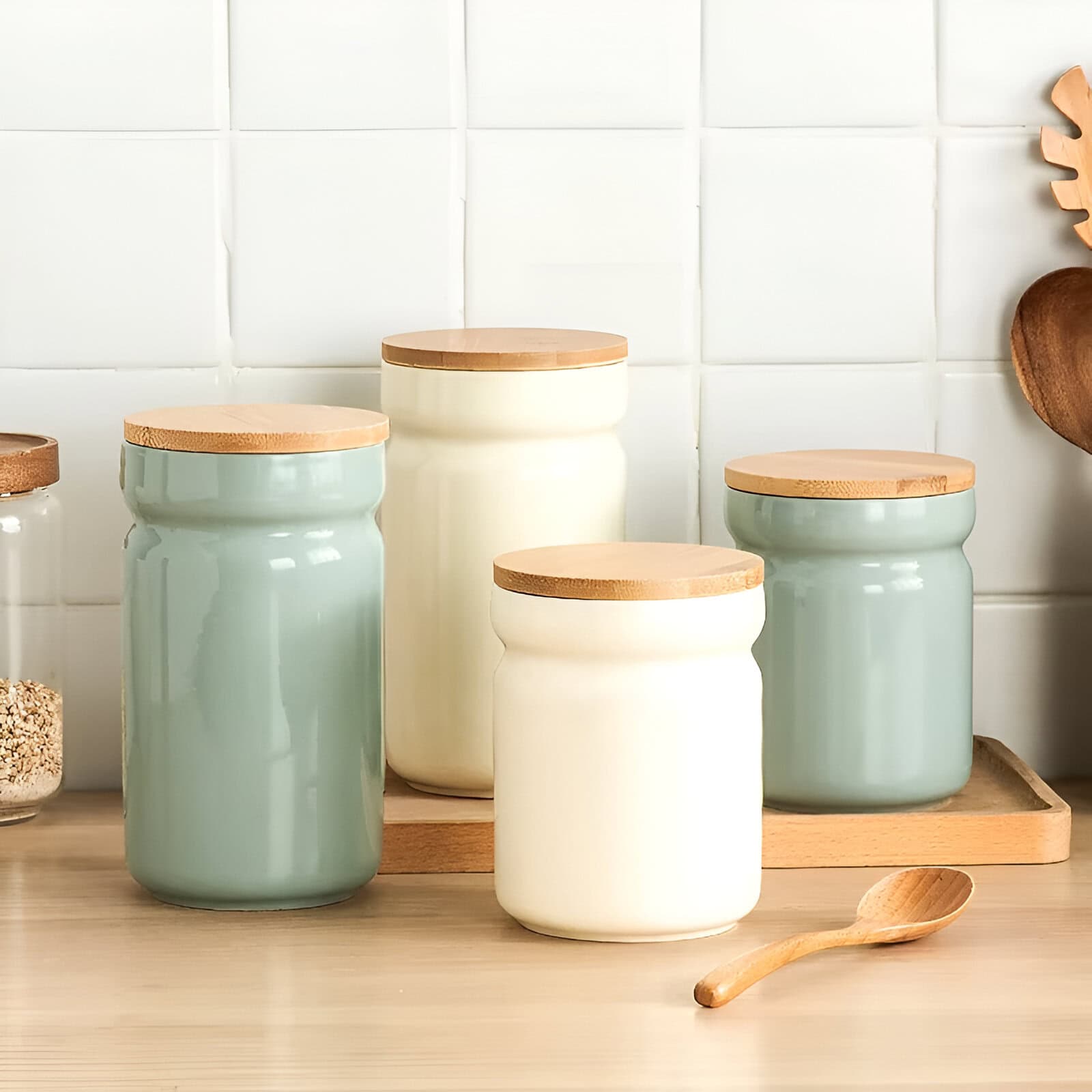 Beautiful ceramic storage jars with wooden lids on a kitchen counter, ideal for organizing spices and ingredients, combining aesthetic appeal with functional kitchen storage.