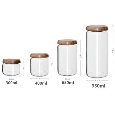 Clear glass storage jars with wooden lids, available in multiple sizes for kitchen organization and storage. Perfect for dry goods, spices, and more, combining functionality and aesthetic appeal.
