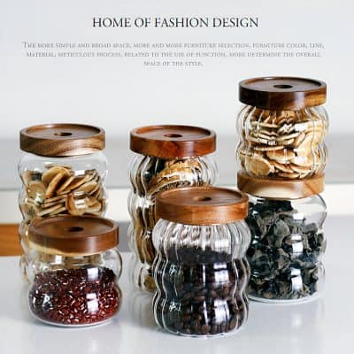 Vintage glass jars with wooden lids filled with assorted dried herbs and spices, stylish storage containers for kitchen organization, Monalisa Store brand, elegant and functional design, ideal for spice storage and decor, modern and rustic aesthetic.