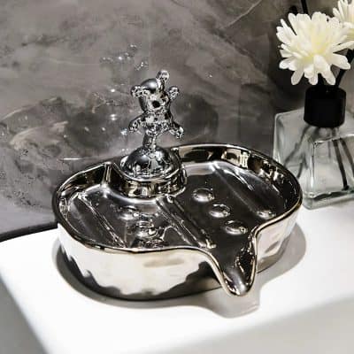 Shiny chrome pet water fountain with bear handle, stylish bathroom decor or dog accessory.