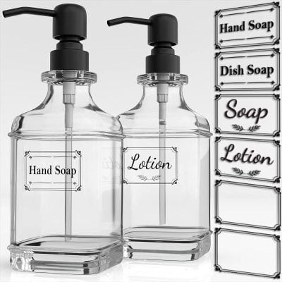 Clear glass soap dispensers with black pump lids labeled 