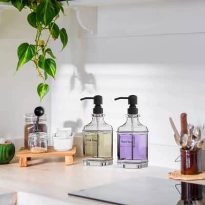 Elegant soap dispensers ideal for modern optometry and eyewear store decor, featuring stylish glass bottles with black pump tops for hygiene and convenience.
