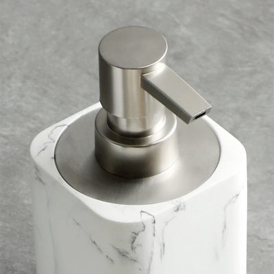 Luxurious marble soap dispenser with brushed metal pump for modern bathroom decor. Perfect for hand hygiene and elegant home or salon settings.