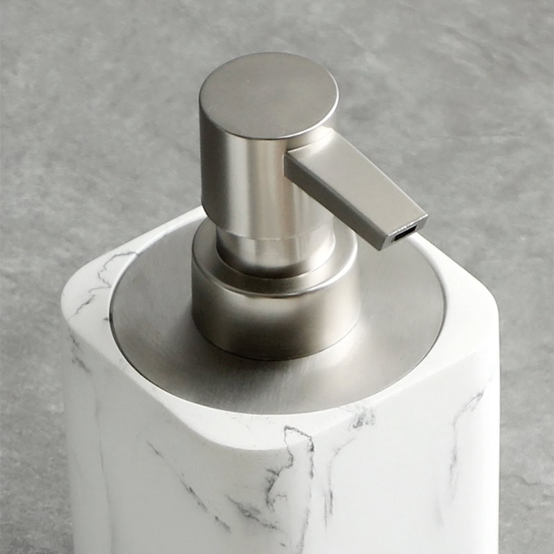 Luxurious marble soap dispenser with brushed metal pump for modern bathroom decor. Perfect for hand hygiene and elegant home or salon settings.