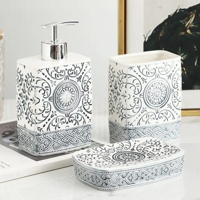 Intricate black and white patterned soap dispenser, toothbrush holder, and tissue box set from Monalisa Store, ideal for elegant bathroom decor and organized storage solutions.