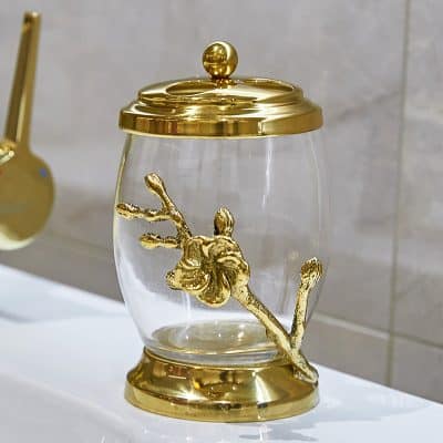 Elegant decorative glass jar with gold floral accents, ideal for luxury home decor and bathroom storage, showcasing high-quality craftsmanship and stylish design.
