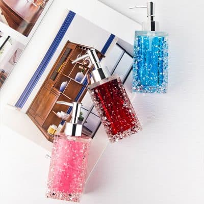 Elegant soap dispensers with colorful gel in a modern bathroom setting. Perfect for adding a touch of style to your skincare routine.