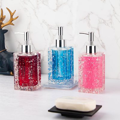 Colorful gel soap dispensers with bubbles on a marble countertop, Ideal for bathroom or kitchen decor, showcasing modern design and vibrant colors for a stylish and functional space.