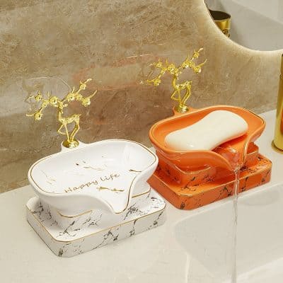 Elegant ceramic soap dispensers with gold deer accents, marble base, and "Happy Life" inscription, perfect for luxury bathroom decor and enhancing aesthetic appeal.