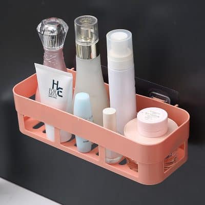 Moisturizer and skincare products organized in a pink storage caddy on a black background, ideal for skincare routines and beauty shop displays.