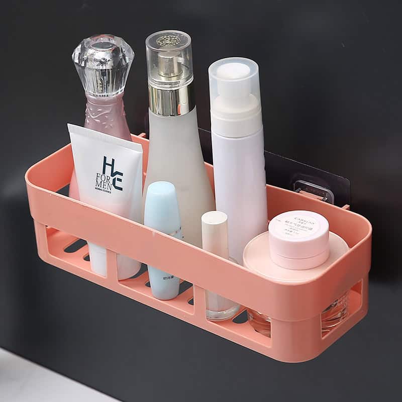 Moisturizer and skincare products organized in a pink storage caddy on a black background, ideal for skincare routines and beauty shop displays.