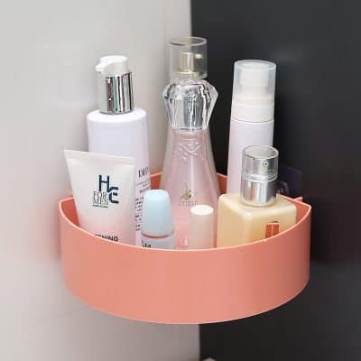Cleaning skincare bottles on pink storage caddy at Monalisa Store.