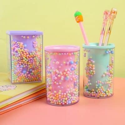 Bright pastel-colored storage containers and stationery sets with colorful beads, perfect for organizing cosmetics, stationery, or accessories at Monalisa Medical Store.