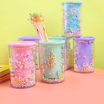 Colorful plastic cups with pastel-colored bubbles and stationery items, perfect for stationery storage and desk organization at Monalisa Store.