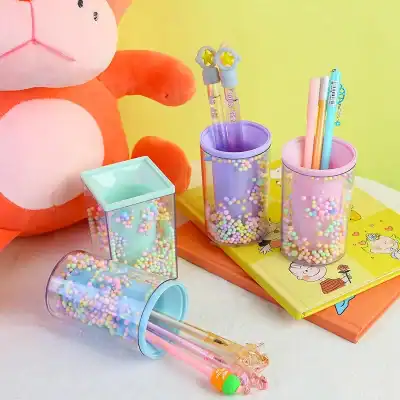 Colorful bubble tea-themed stationery set with pens, pencils, and storage containers in pastel pink, purple, and blue, perfect for organizing school supplies or desk accessories.