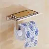 Smartphone holder with tissue paper on bathroom wall, modern bathroom accessory, bathroom essentials, wall-mounted tissue dispenser, hygiene and convenience for bathroom use.