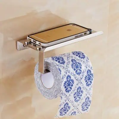 Smartphone holder with tissue paper on bathroom wall, modern bathroom accessory, bathroom essentials, wall-mounted tissue dispenser, hygiene and convenience for bathroom use.