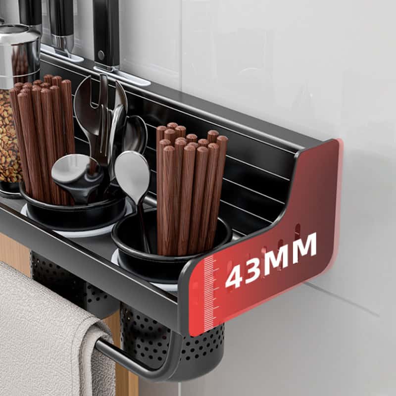 Stainless steel kitchen utensil rack holding cooking spoons, chopsticks, and kitchen tools with measurement marks for optimal storage and organization.