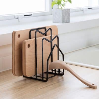 Wooden cutting boards with metal racks for kitchen storage, modern minimalist design ideal for food prep and organization.