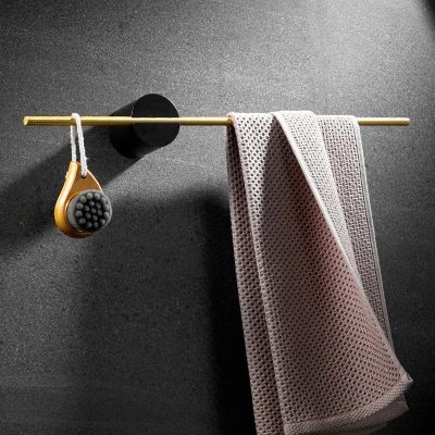 Soft cleaning cloths and massage brush hanging on a gold rod, designed for optical care and cleaning, ideal for eyeglasses and lenses at Monalisa Store.