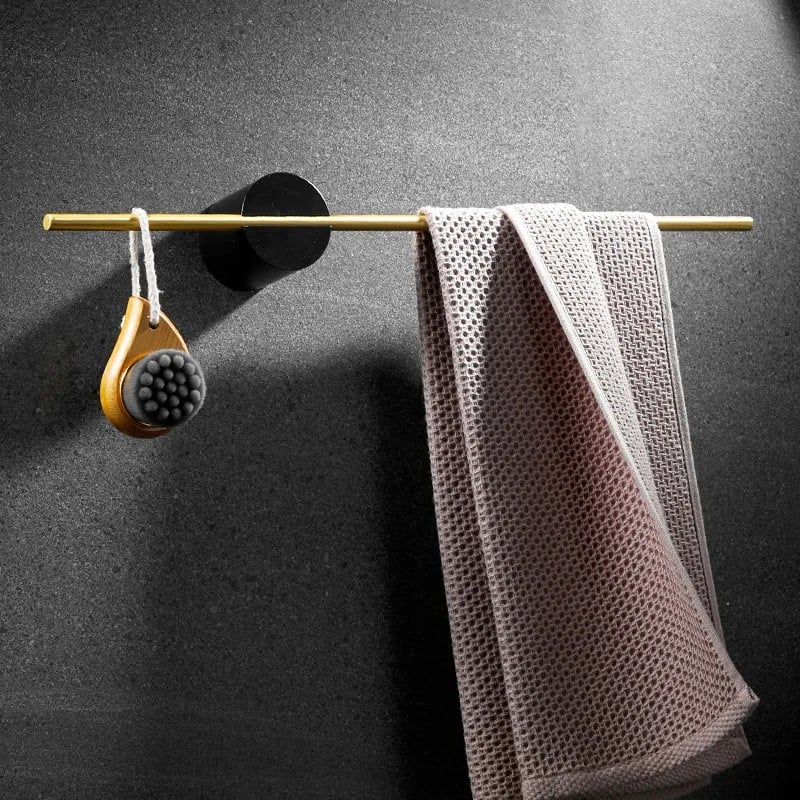 Soft cleaning cloths and massage brush hanging on a gold rod, designed for optical care and cleaning, ideal for eyeglasses and lenses at Monalisa Store.