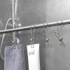 Clothesline with hanging cloth and tags inside a shower on a rainy day, showing waterproof and moisture-resistant fabrics ideal for bathroom or outdoor use.