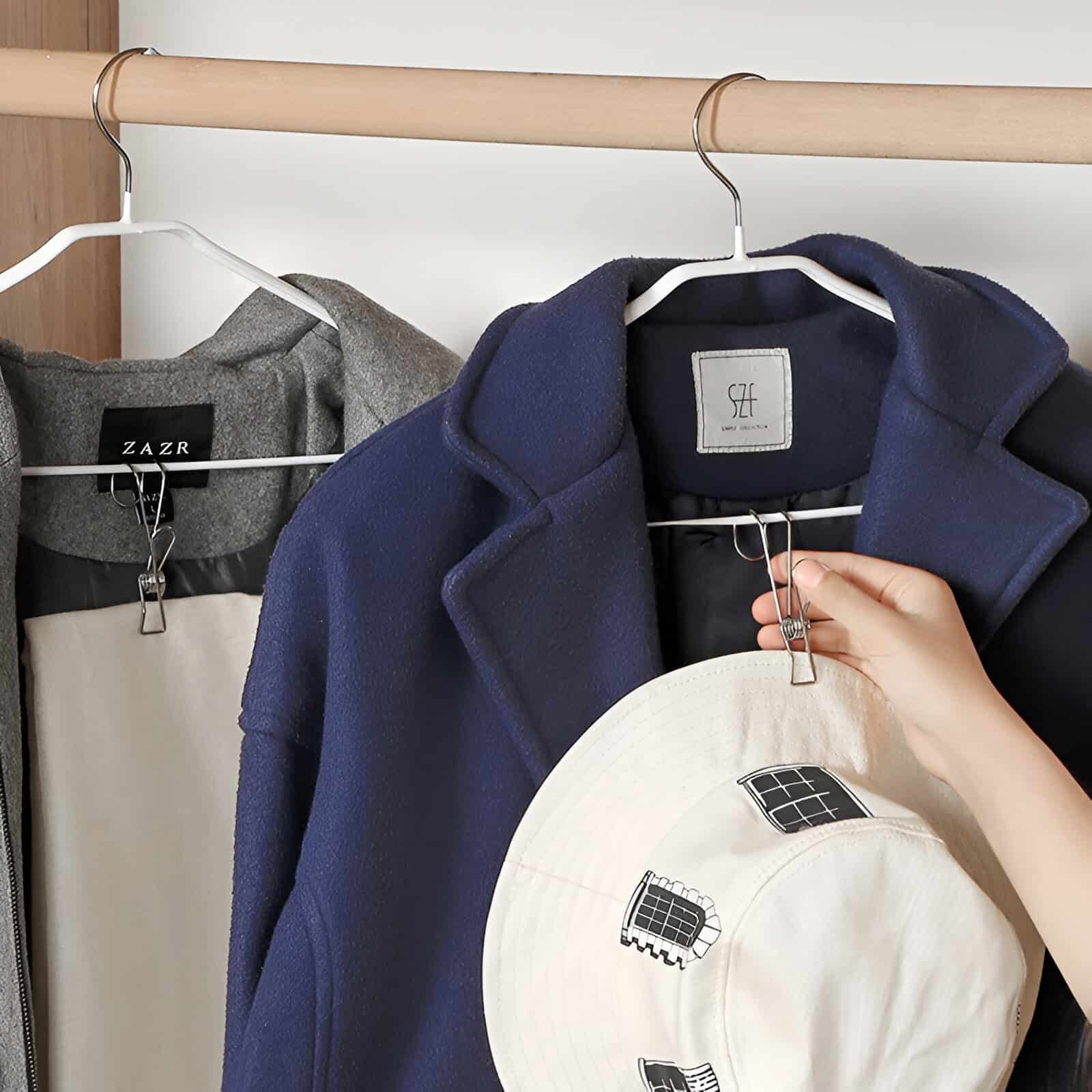 Luxury women's coat in navy blue hanging on a wardrobe rail, stylish outerwear for fall and winter, fashionable and comfortable clothing from Monalisa Store.