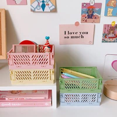 Colorful plastic storage baskets with stationery and art supplies on a white desk, complemented by wall art and a pink quote sign. Perfect for organizing kids' art projects and creative materials at Monalisa Store.