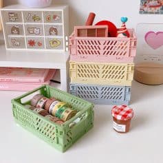 Bright colorful storage baskets and cute decorative tape rolls on a white desk, perfect for organizing arts and crafts supplies, toys, or stationery in a playful, kid-friendly room.