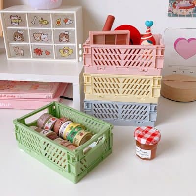 Bright colorful storage baskets and cute decorative tape rolls on a white desk, perfect for organizing arts and crafts supplies, toys, or stationery in a playful, kid-friendly room.