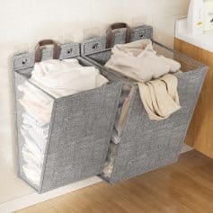 Stacked laundry hampers with neatly folded white and beige towels, ideal for organized laundry storage in a modern bathroom or laundry room setting.