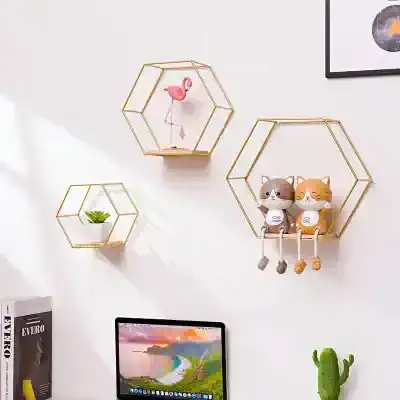 Colorful geometric wall shelves with decorative toys, plants, and a computer monitor creating a modern, playful, and organized workspace aesthetic.
