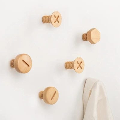 Wooden coat hooks with screw design on white wall, modern minimalistic decor, Monalisa Store opt furniture, stylish organization and home accessories.