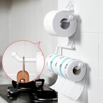 Toilet paper holder with multiple rolls and decorative hanging sign in a modern bathroom, showcasing space-saving and organized bathroom essentials.