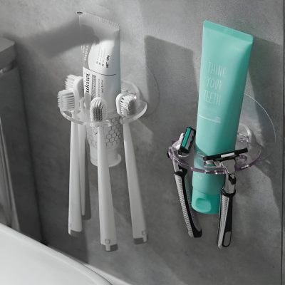 Qwahs toothbrushes and dental hygiene tools on a bathroom wall.