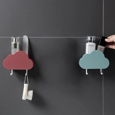Pink cloud-shaped vanity wall holder for toiletries and beauty tools.