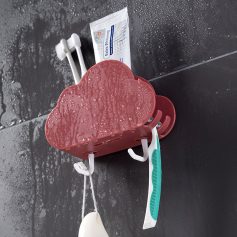 Red heart-shaped soap dish with water droplets on black tiled bathroom wall for dental care storage.
