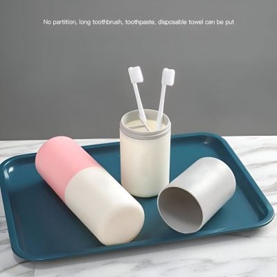 Disposable toothbrush and toothpaste container with brushes on a blue tray, free of partitions, for hygienic oral care.