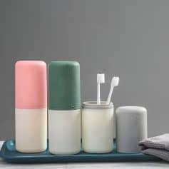 Moisturizing skincare bottles and toothbrush holders on a tray, showcasing luxury beauty and skincare products ideal for eye health and facial care routines.